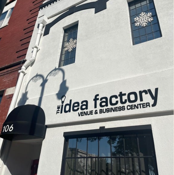Building exterior featuring "idea factory" sign and decorative window designs.